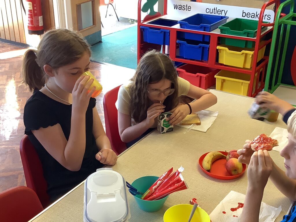 Two girls eating at a table